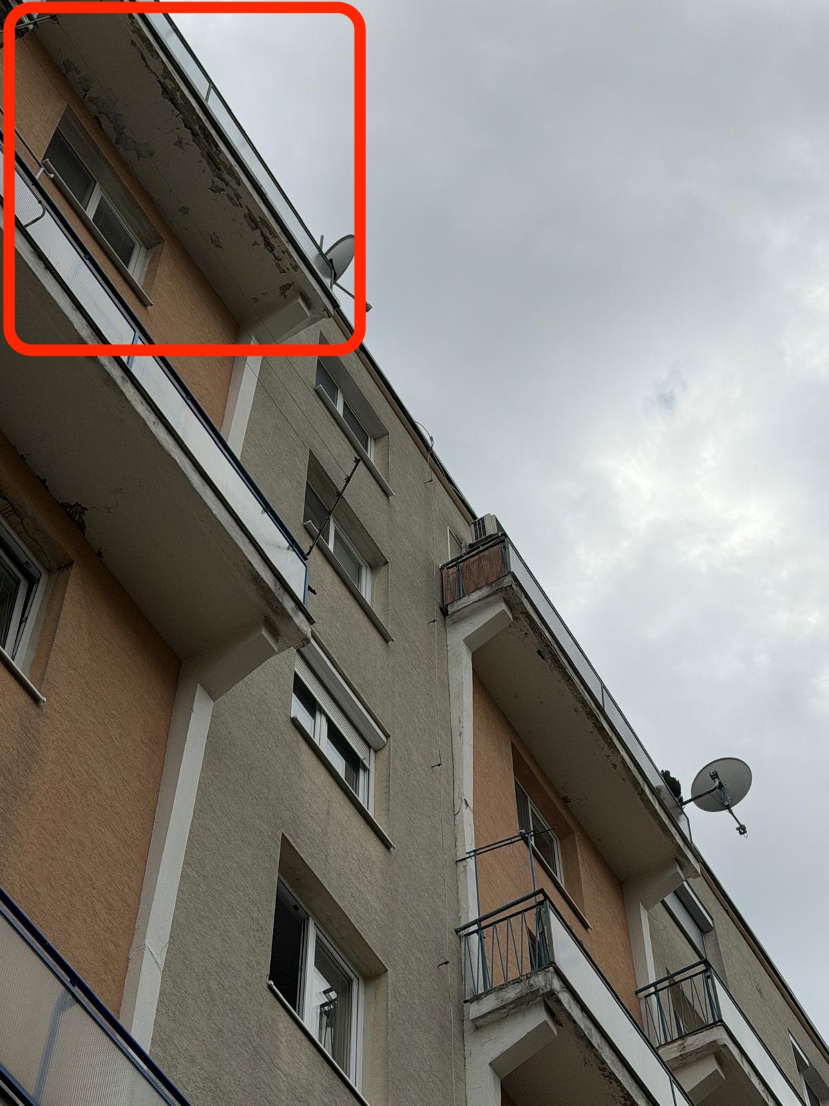 Odlomený kus balkónovej platne nad vchodom